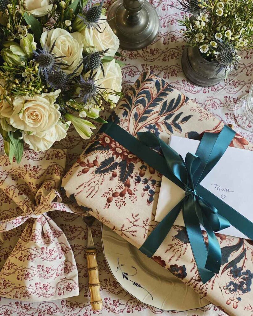 Thanksgiving table with roses gift and patterned linens