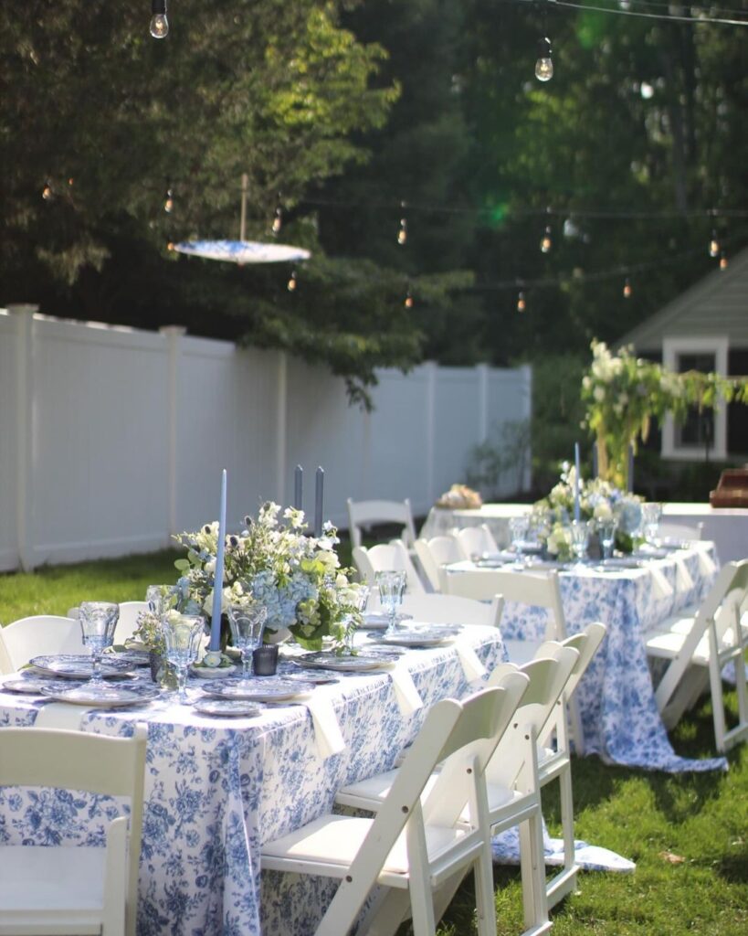 Outdoor Thanksgiving tables with blue floral tablecloths