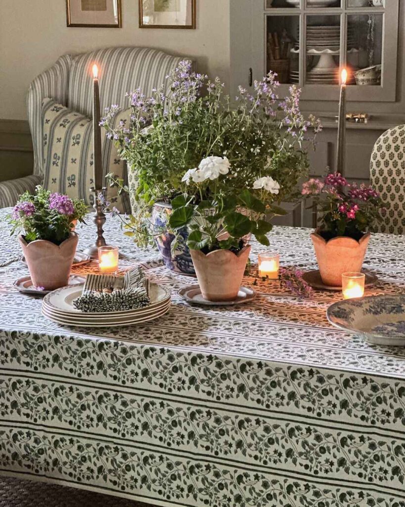 Thanksgiving table with potted flowers and candles