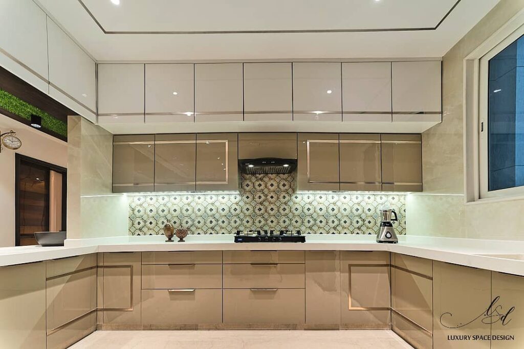 Modern U-shaped kitchen with geometric backsplash and two-tone cabinets.