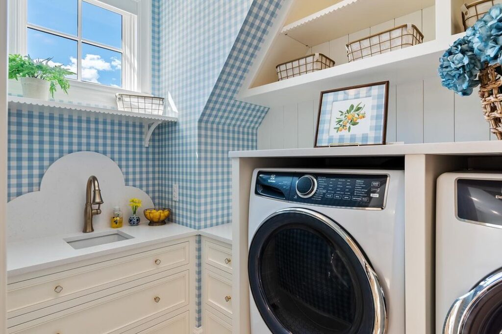 Gingham-wallpapered laundry room with modern appliances.