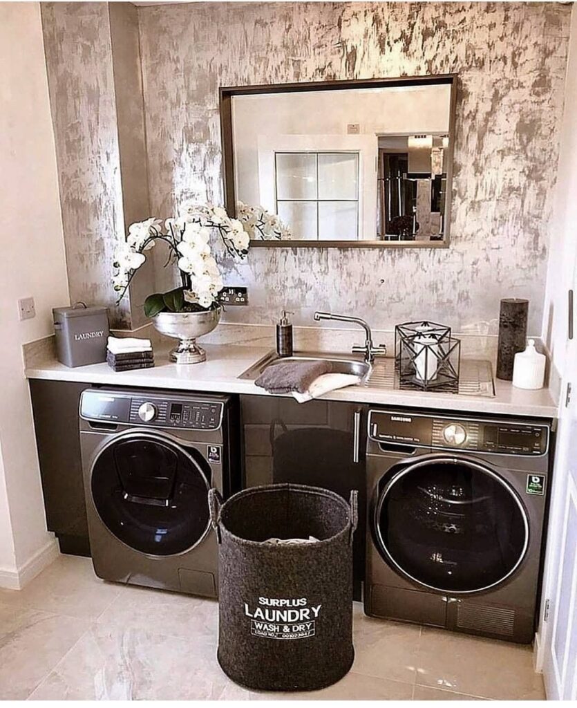 Luxurious laundry room with metallic walls and modern appliances