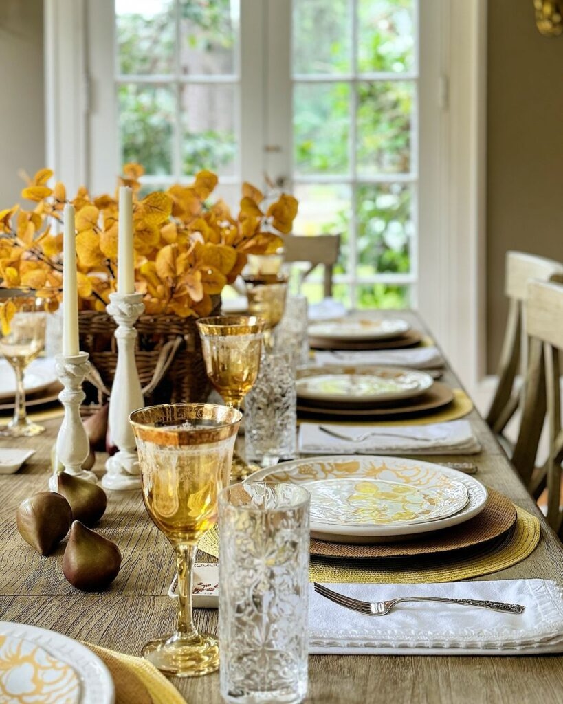 Elegant Thanksgiving table with golden decor and autumn leaves