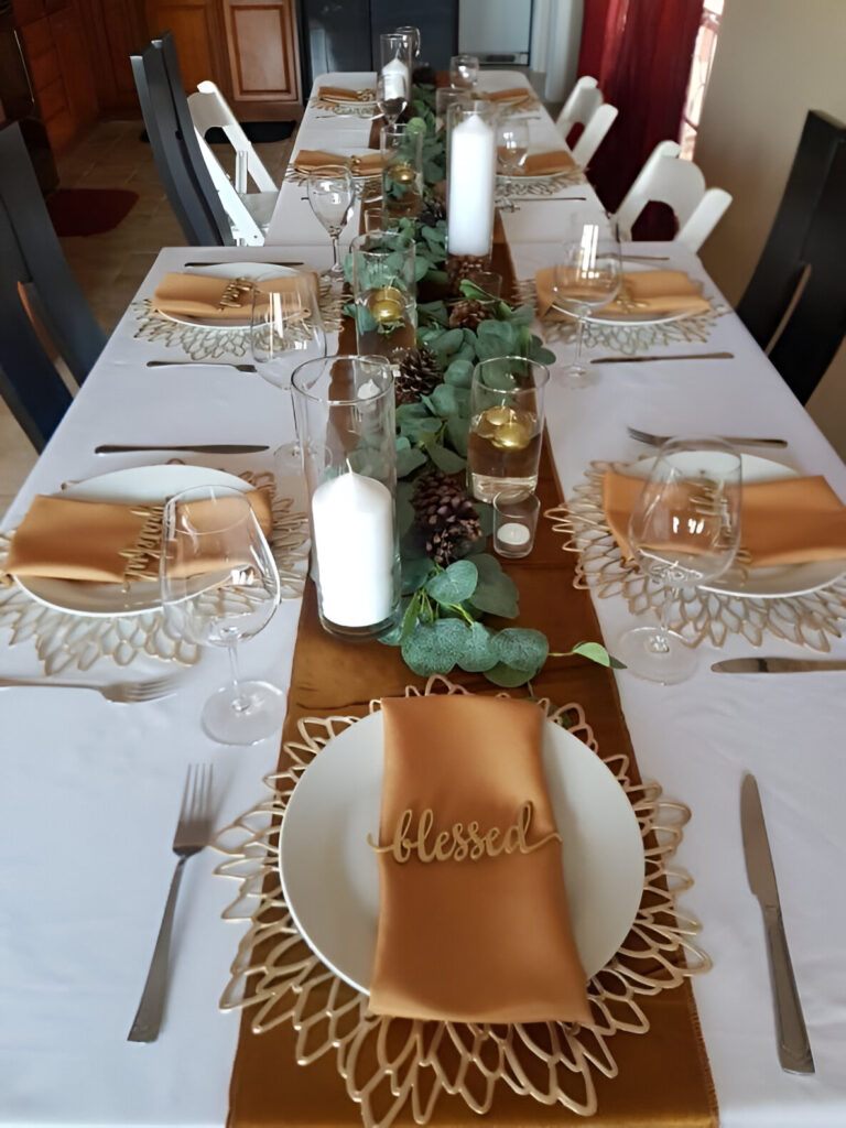 Elegant Thanksgiving table with gold accents and eucalyptus runner