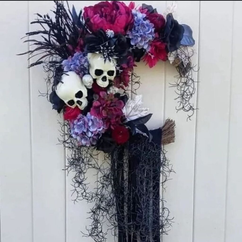 Floral Halloween wreath with skulls and feathers.