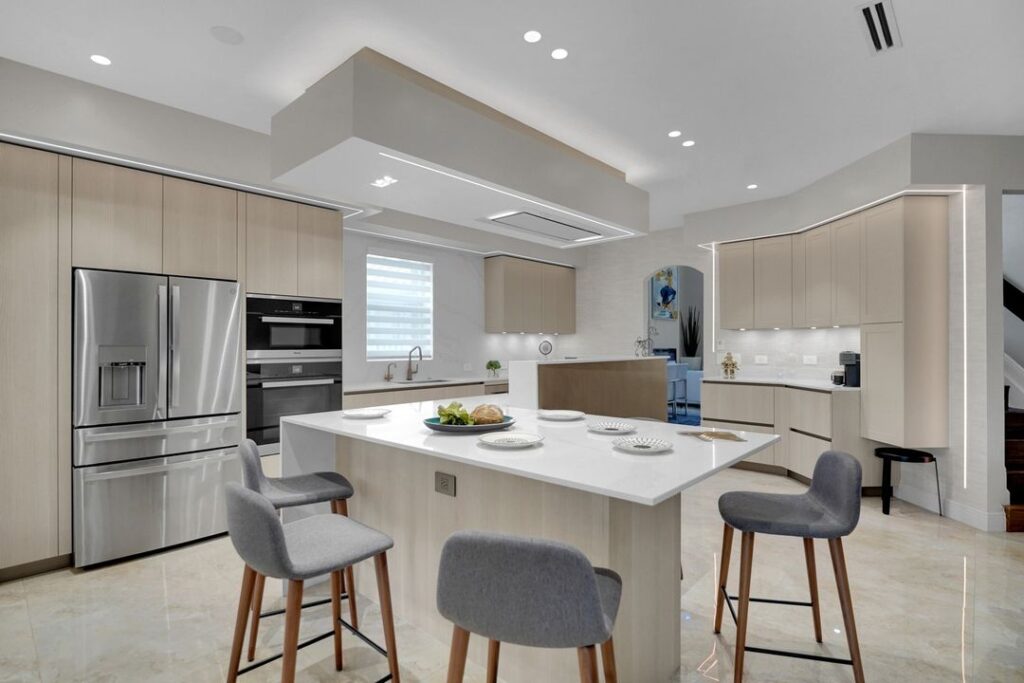 Modern kitchen with light wood cabinets and white island