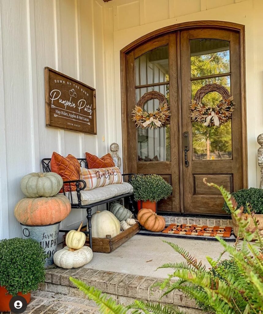 Cozy porch with autumn wreaths pumpkins and fall decor