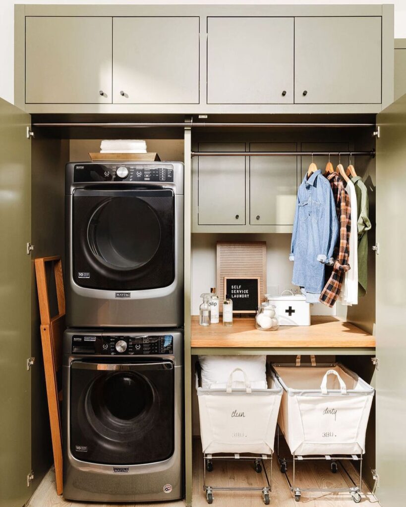 Concealed laundry area with stacked washer-dryer and organized storage.