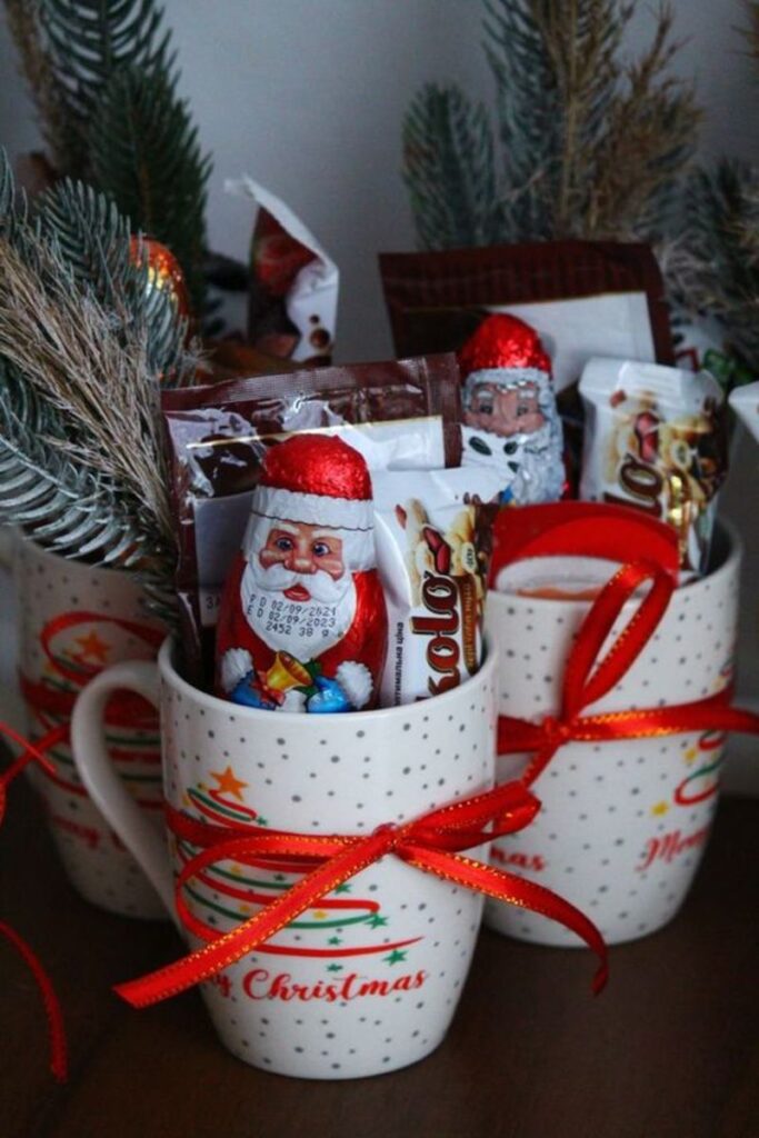 Christmas mugs filled with chocolates and decorations