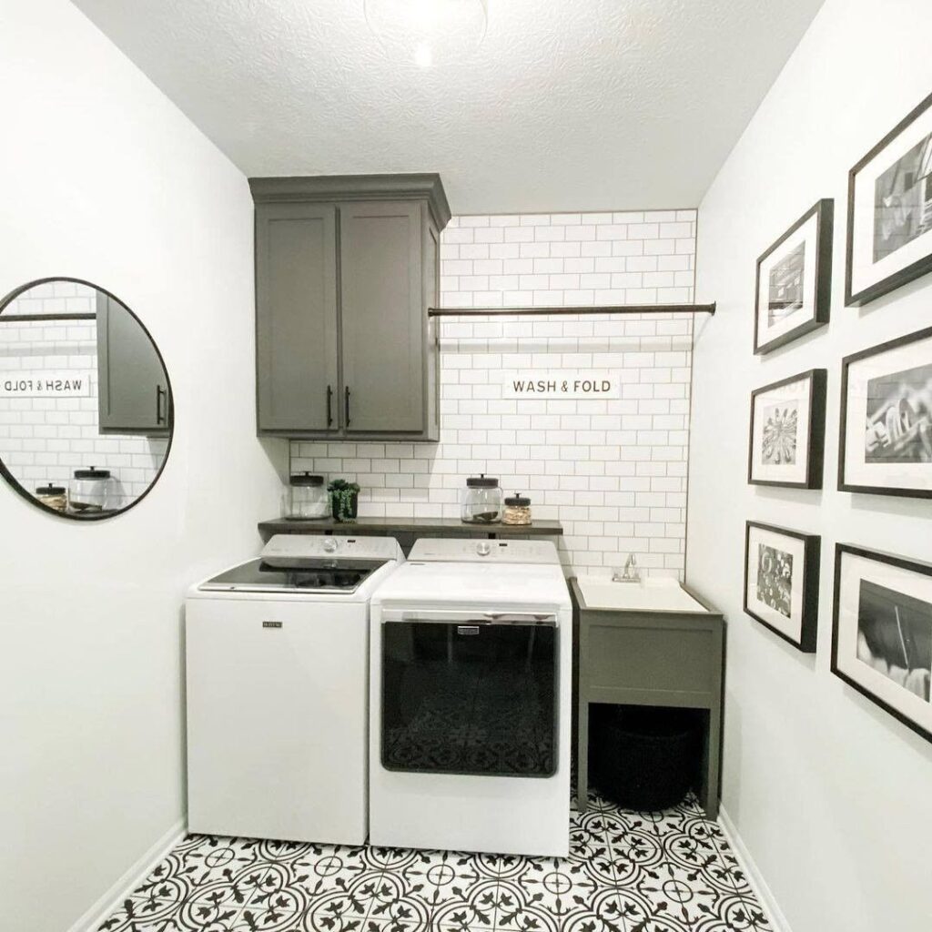 Stylish laundry room with top-load washer patterned floor and gallery wall.