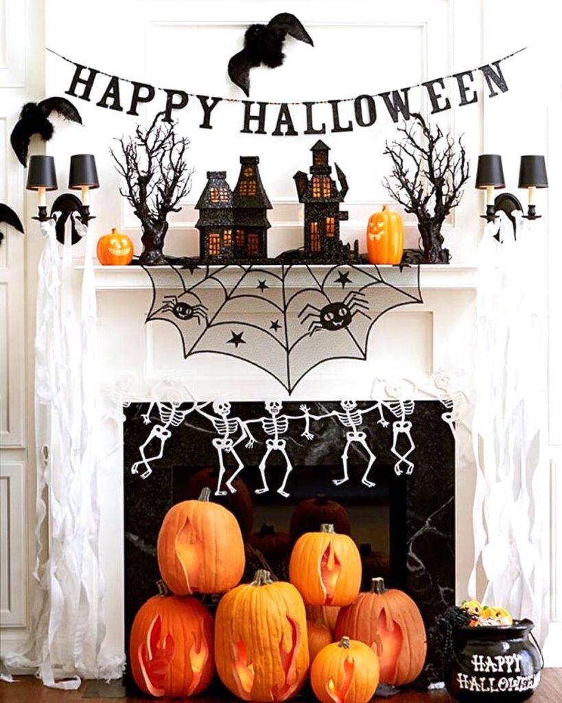 Halloween mantel with black decorations and glowing pumpkins