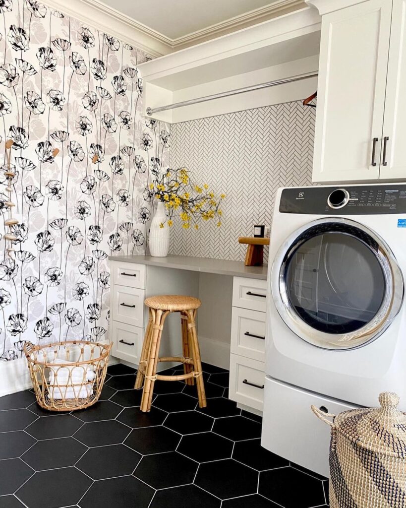 Laundry room with black and white poppy wallpaper and hexagon tiles.