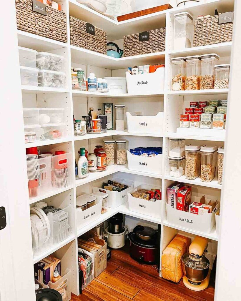 Organized pantry with labeled bins baskets and jars