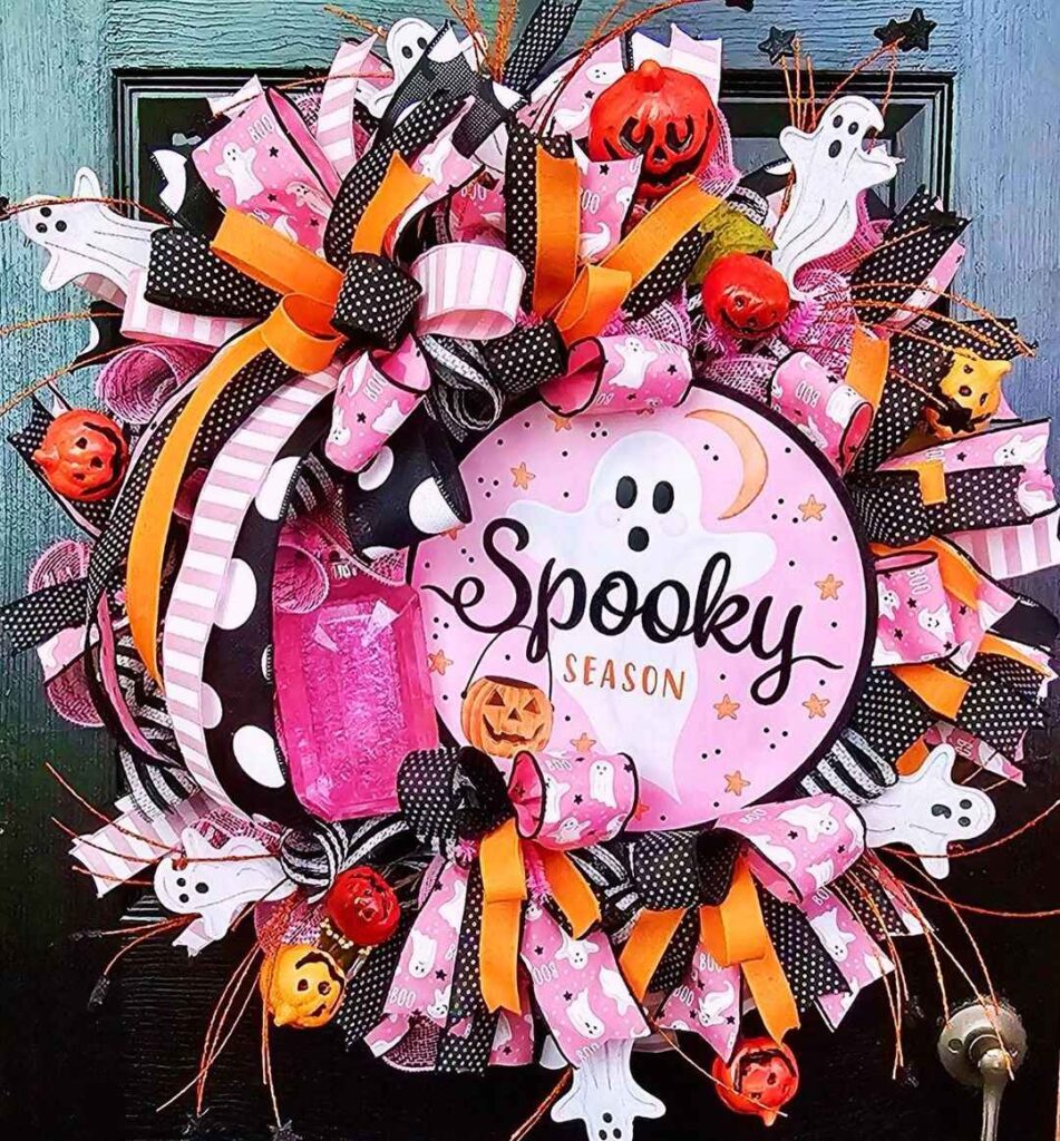 Pink Halloween wreath with ghosts and Spooky Season sign.