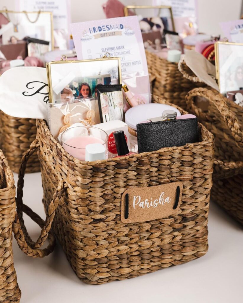 Wicker basket with bridesmaid gifts and personalized tag