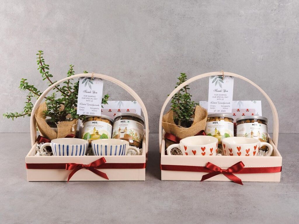 Two gift baskets with mugs tea jars and succulents