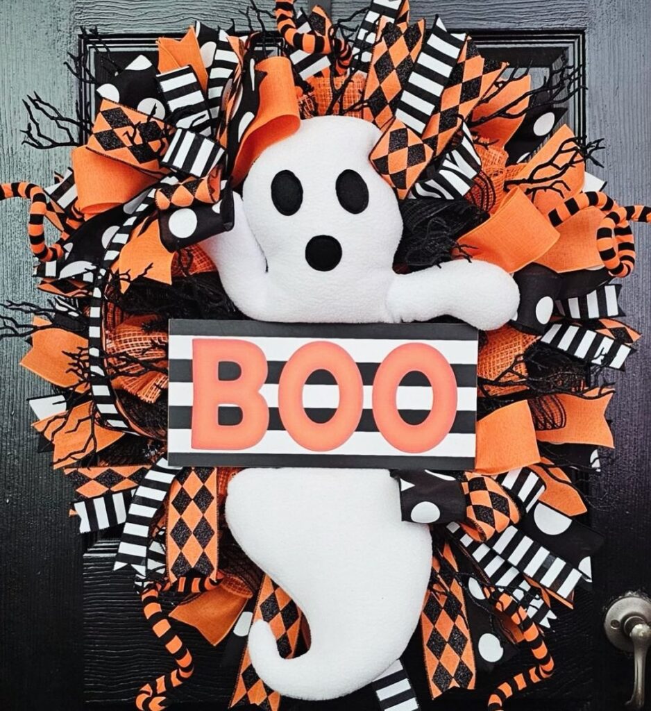 Halloween wreath with white ghost BOO sign and orange black ribbons.