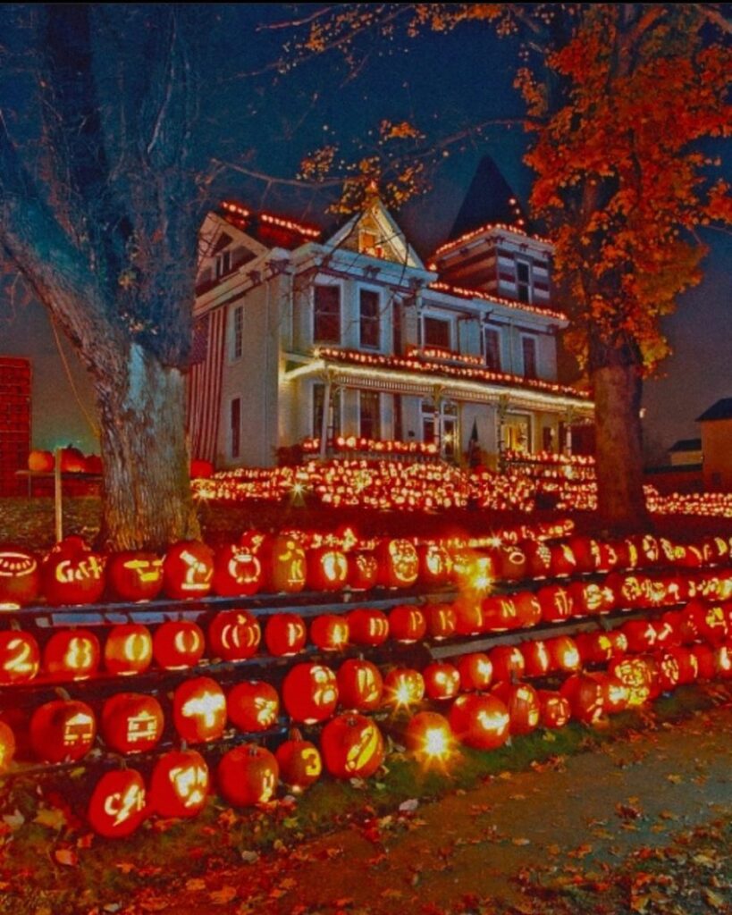 House surrounded by glowing carved pumpkins