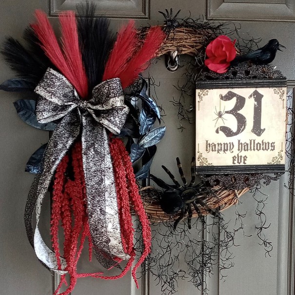 Halloween wreath with feathers raven and illuminated 31 sign.