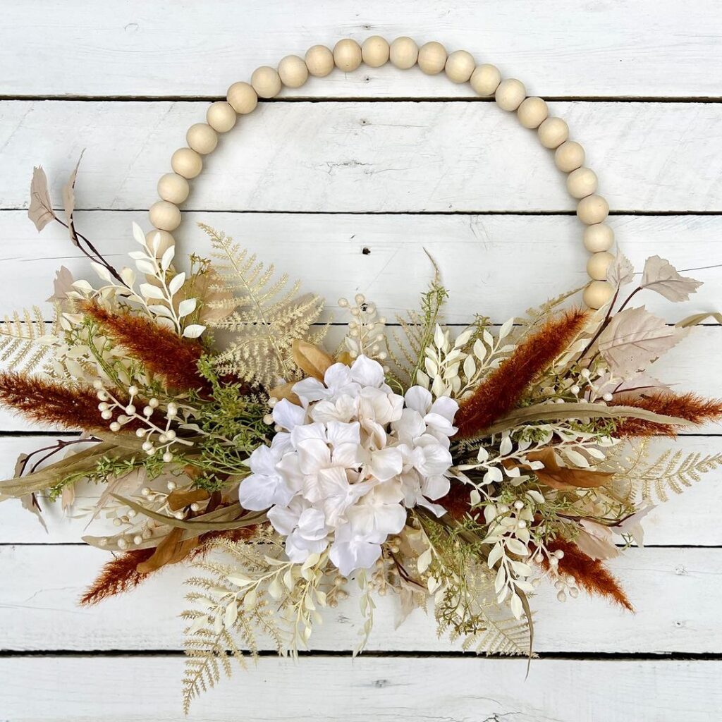 Beaded hoop wreath with dried autumn florals.