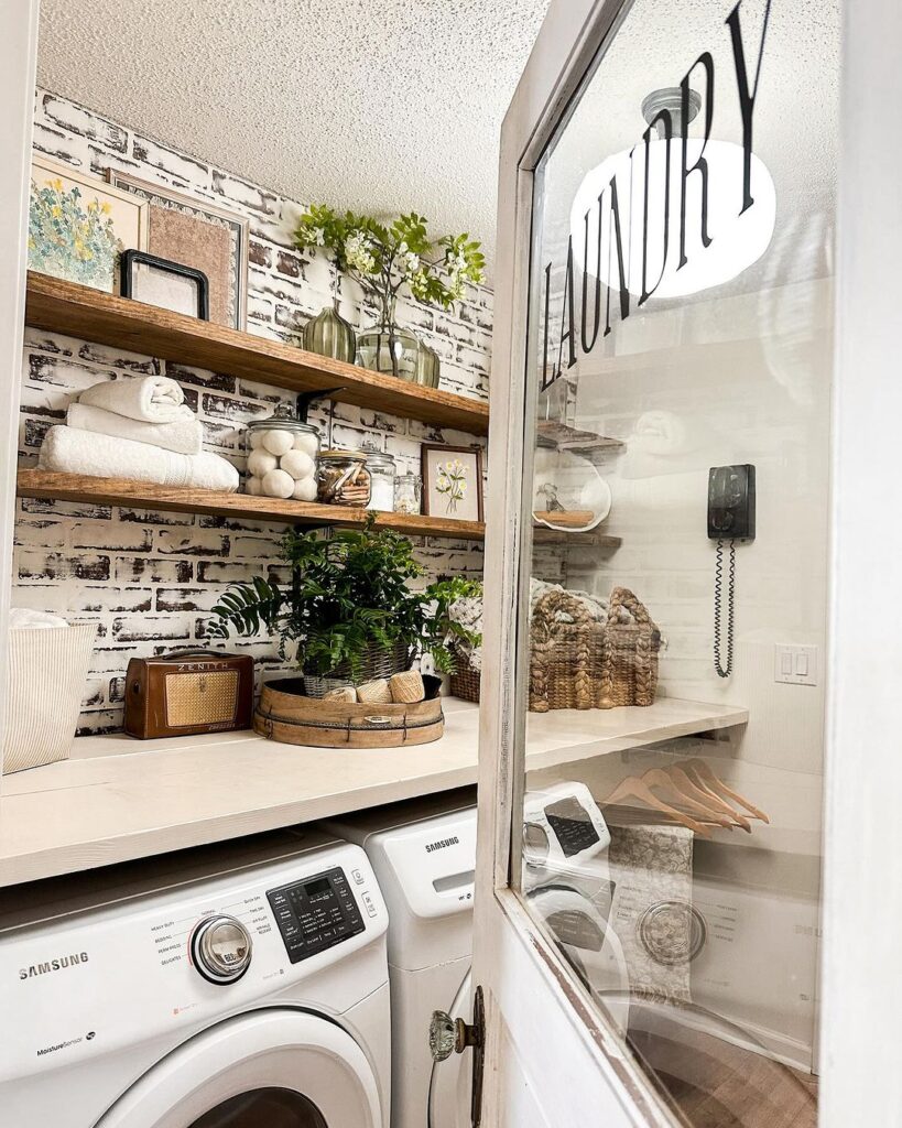 Laundry room with brick wall wooden shelves and white washer