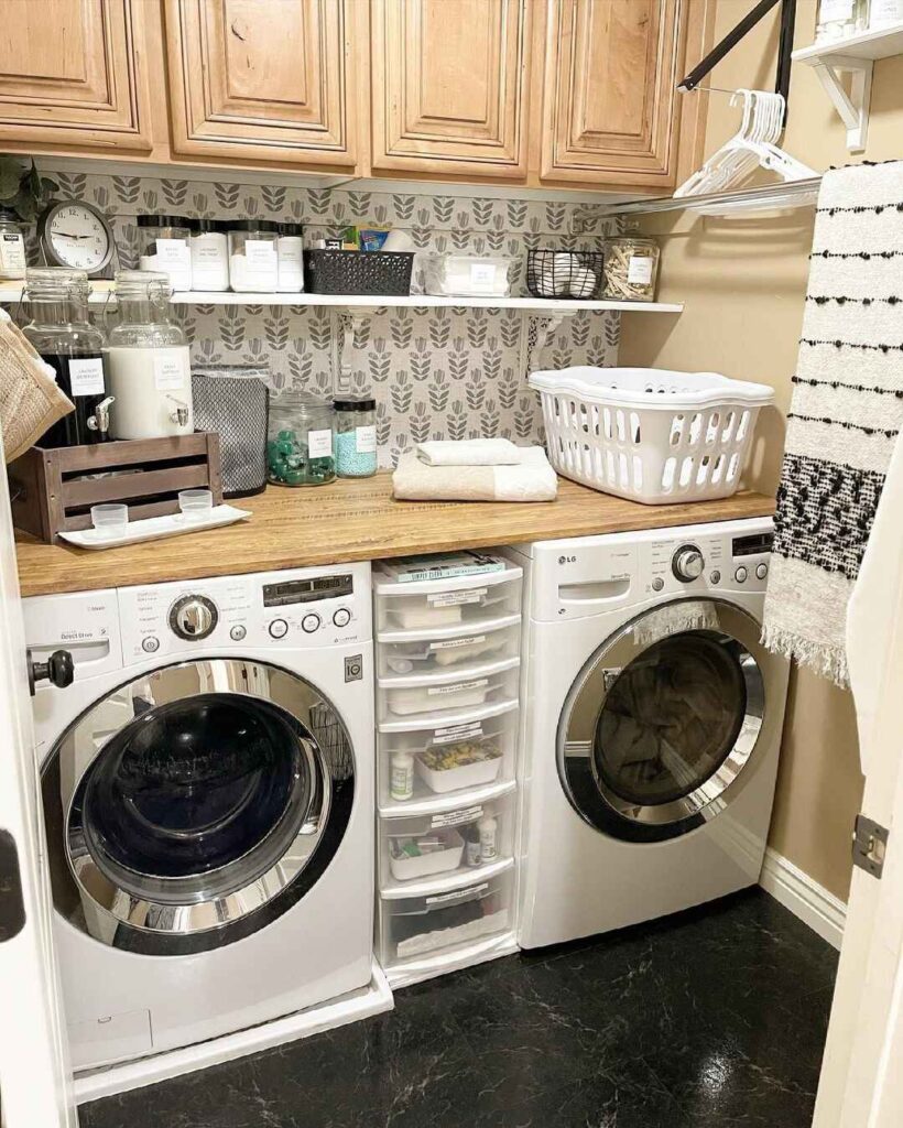 Efficient laundry room with floral wallpaper and wooden accents.