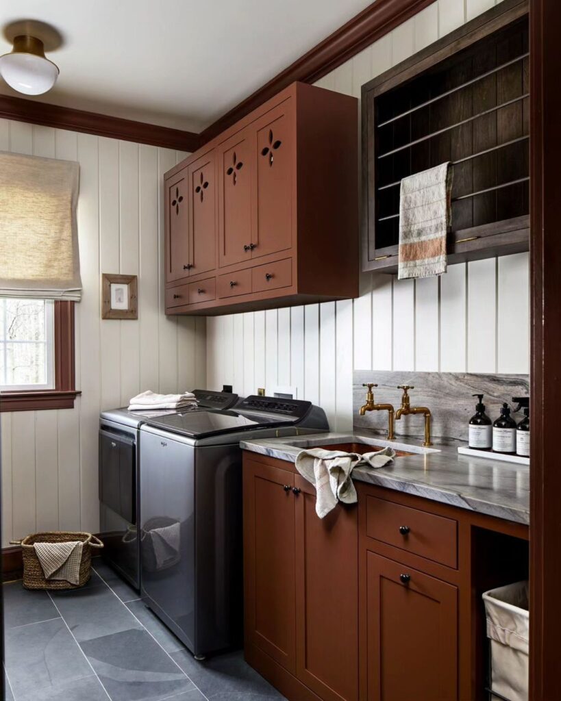  Laundry room with terracotta cabinets and modern appliances