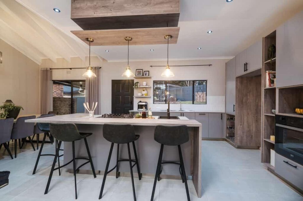 Open kitchen with wood ceiling island and grey cabinets