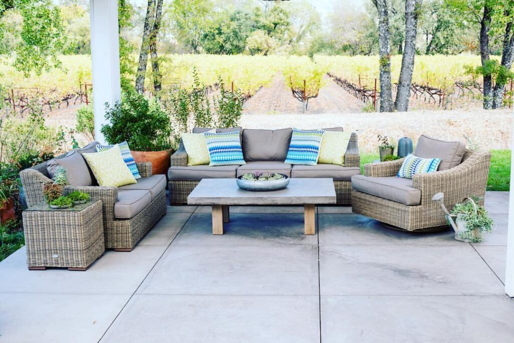 Wicker patio furniture overlooking scenic vineyard rows