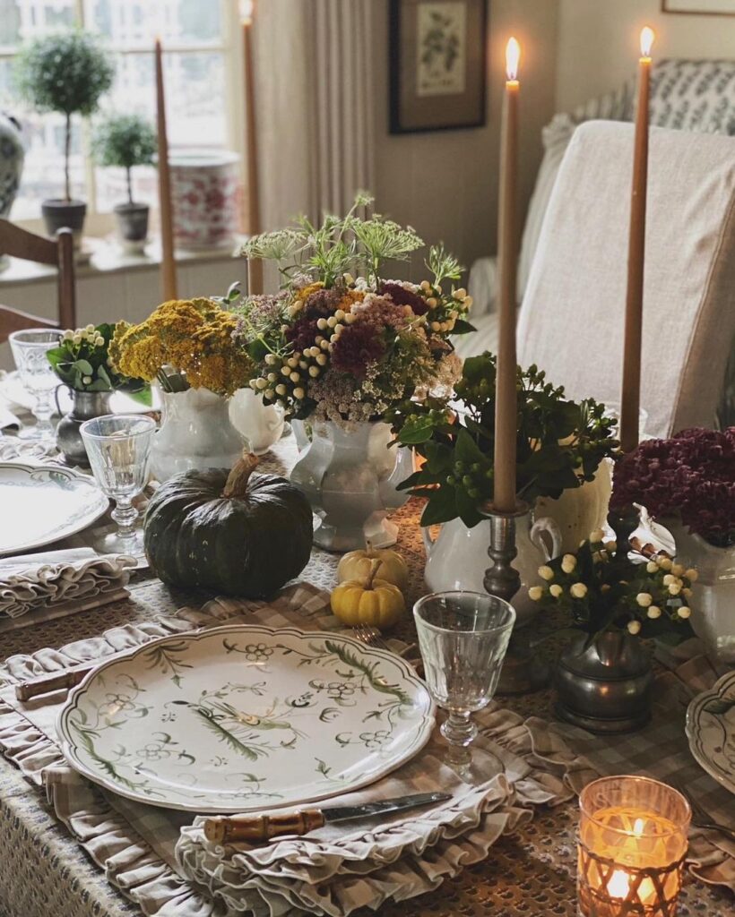 Elegant Thanksgiving table with floral centerpieces pumpkins and candles