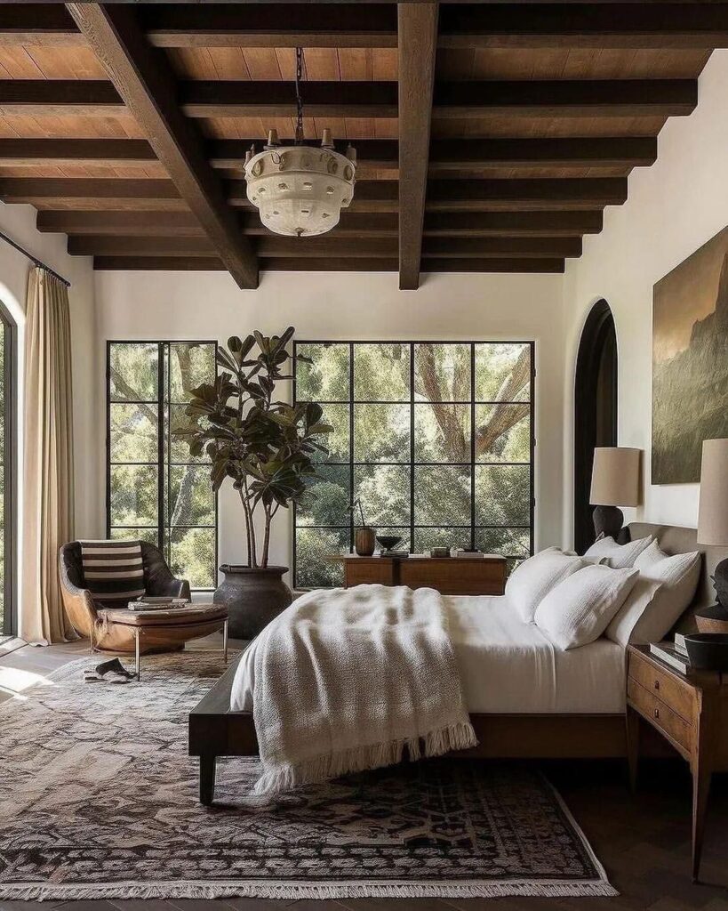 Rustic bedroom with wooden beams and large windows