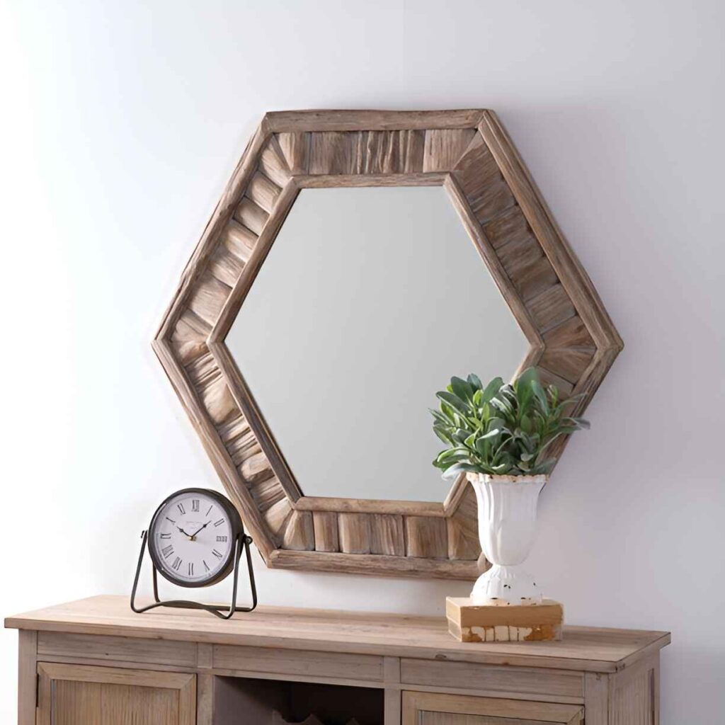 Hexagonal wooden mirror above rustic console table.