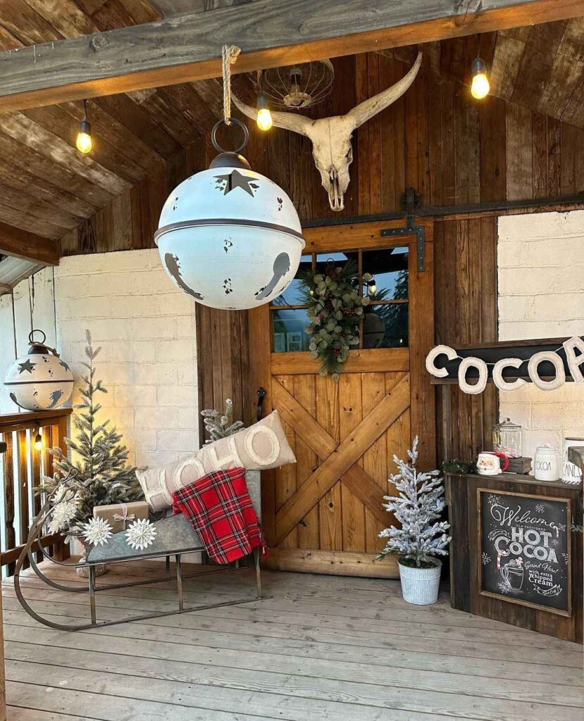 Rustic Christmas decor with sleigh barn door and jingle bell lights