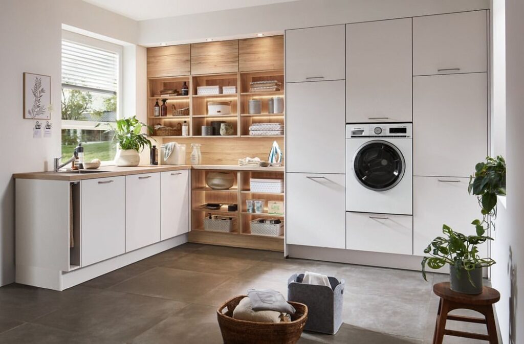 Modern laundry room with wood accents and built-in storage.