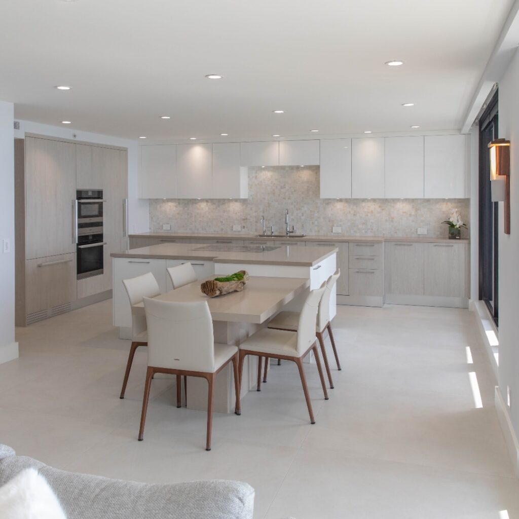 Bright white kitchen with integrated dining area and neutral tones