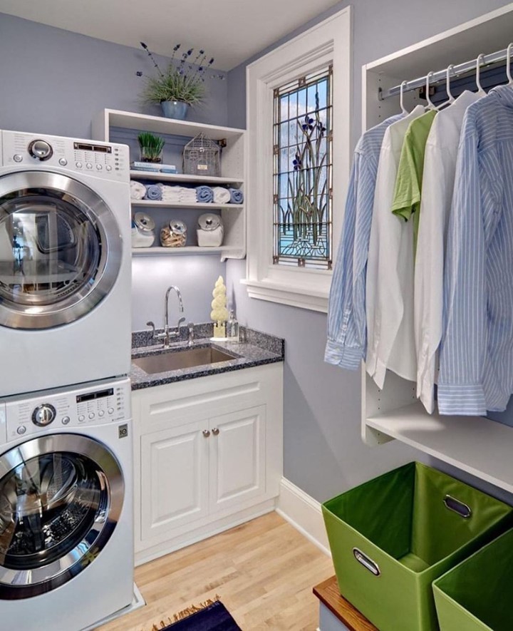 Lavender laundry room with stacked appliances and hanging space.