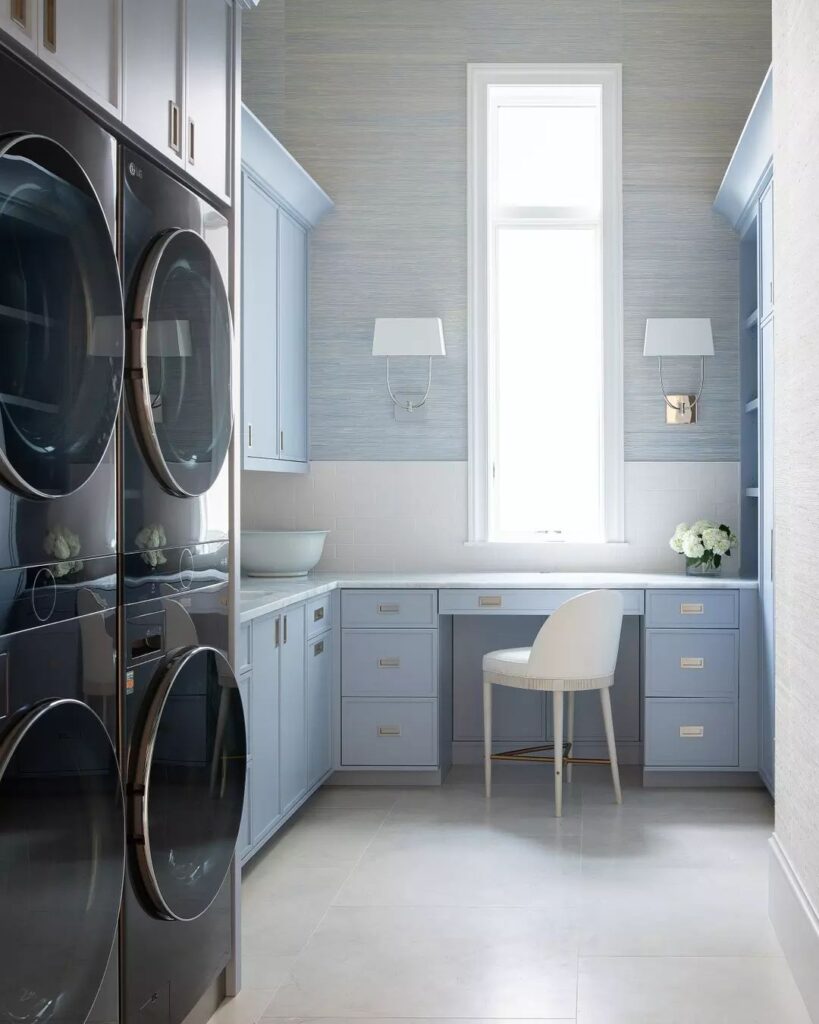 Luxurious blue-gray laundry room with vanity.