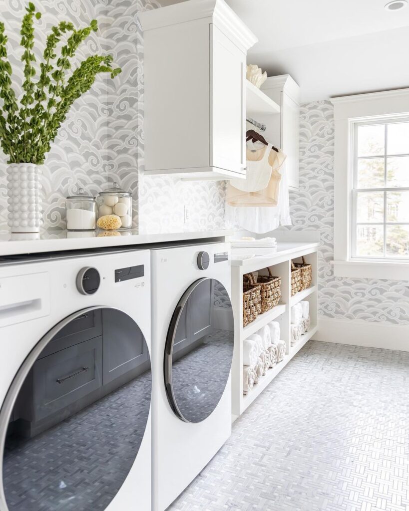 Bright laundry room with swirl wallpaper and organized open shelving.