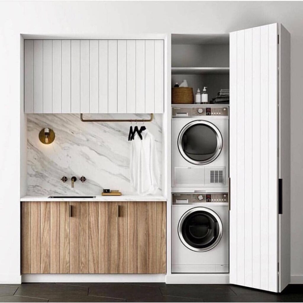 Hidden laundry in sleek modern mudroom combo.