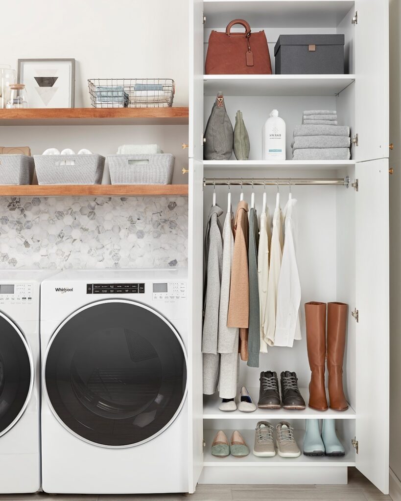 Organized laundry room with closet and modern appliances