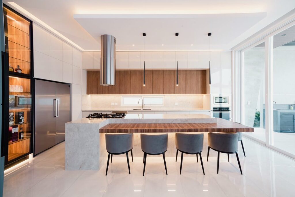 Modern kitchen with wooden accents white cabinets and island seating