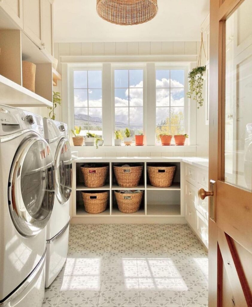 Bright laundry room with large windows and plant decor