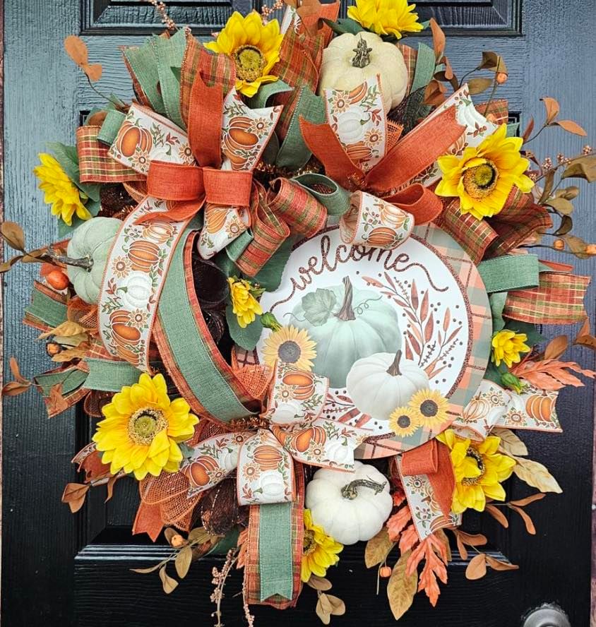 Autumn wreath with sunflowers pumpkins and welcome sign.