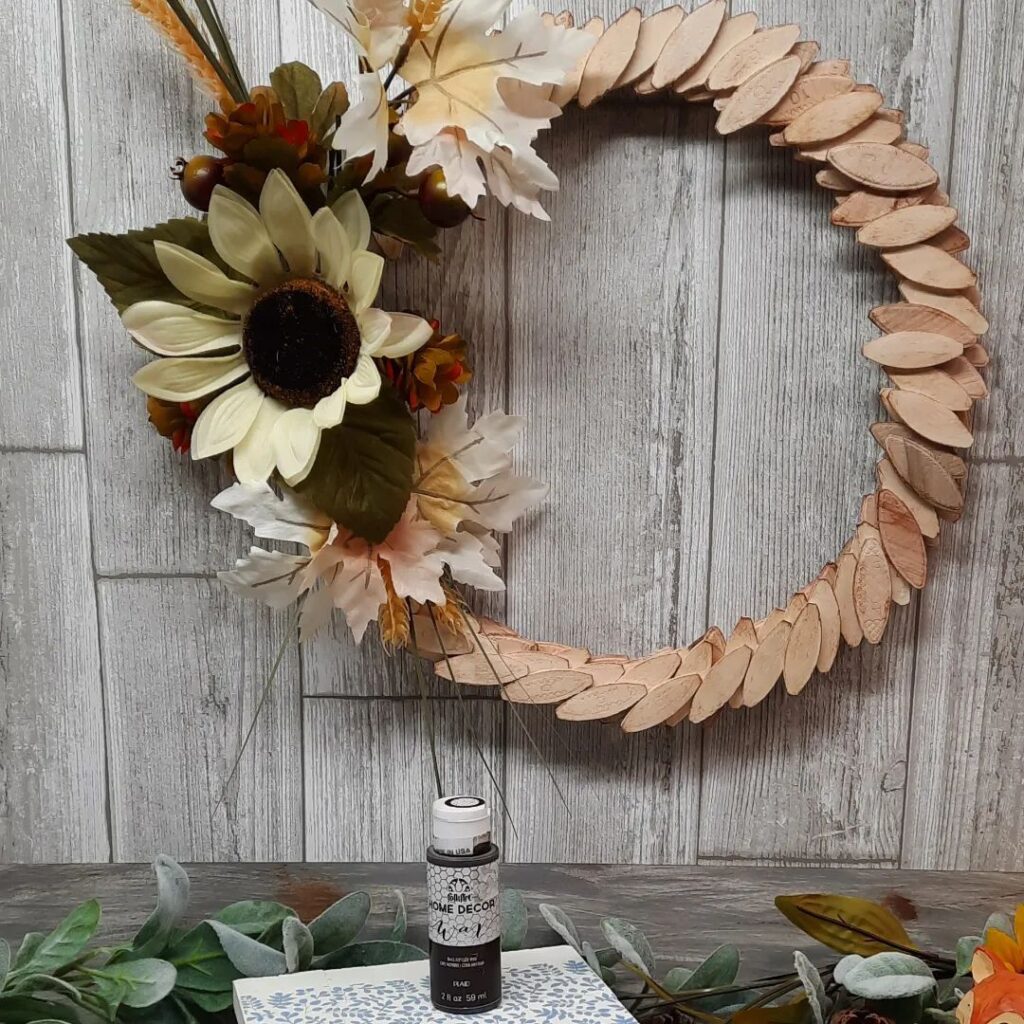 Handmade fall wreath with wood slices and sunflower