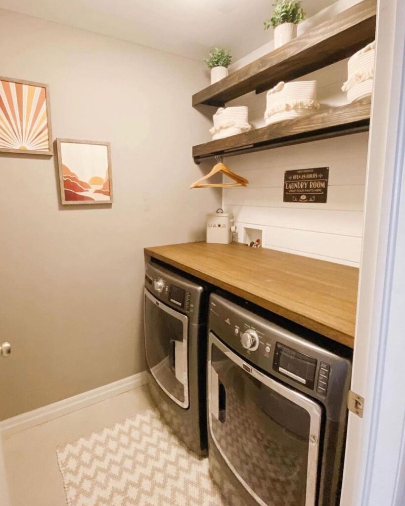 Laundry room with wooden shelves sunset artwork and modern appliances