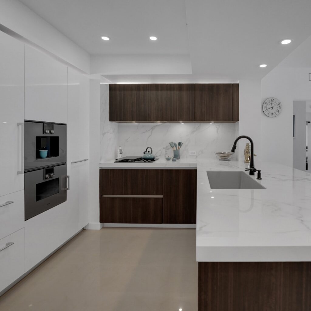 Modern kitchen with white marble and dark wood cabinets