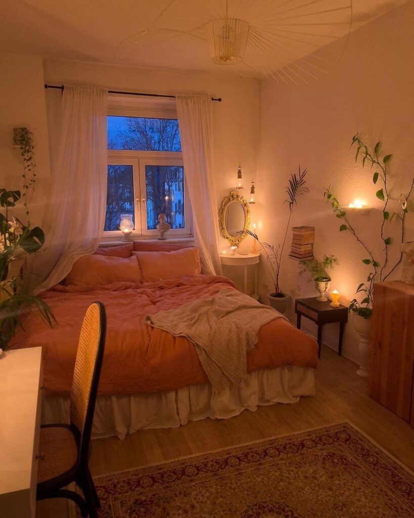 Cozy bedroom with warm lighting plants and window view at dusk