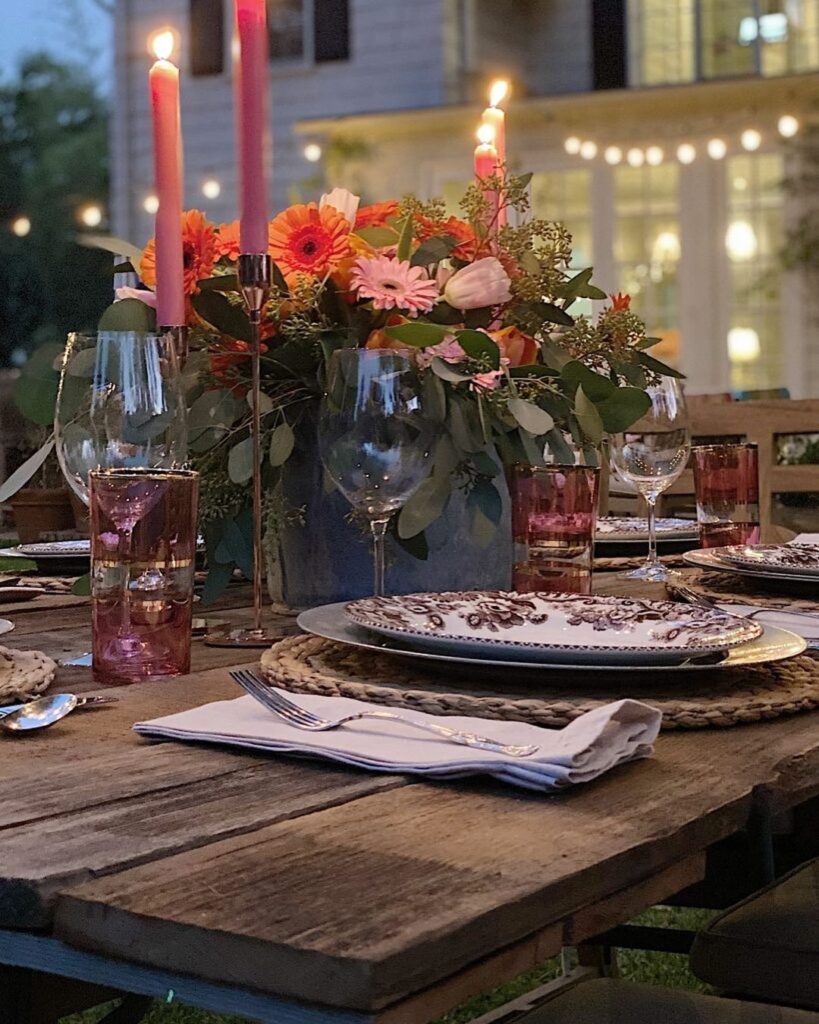 Outdoor Thanksgiving table with floral centerpiece and candlelight