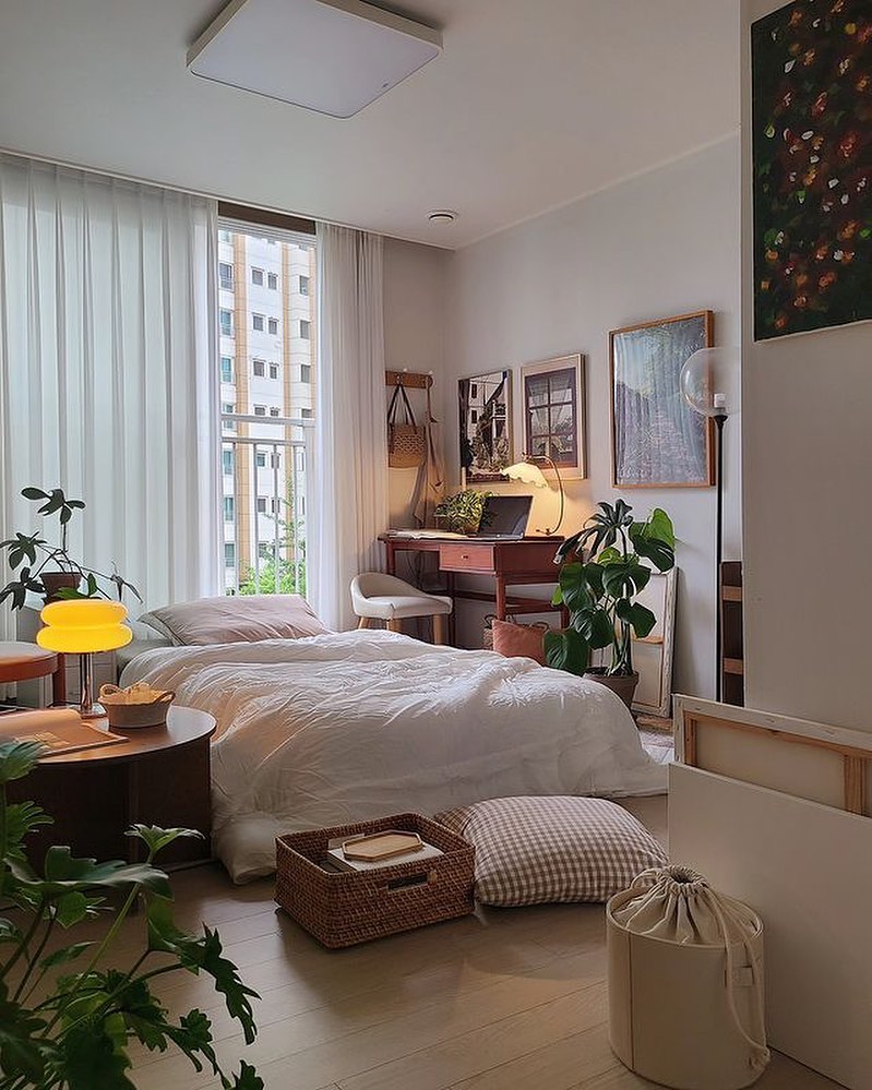 Cozy urban bedroom with workspace and plants