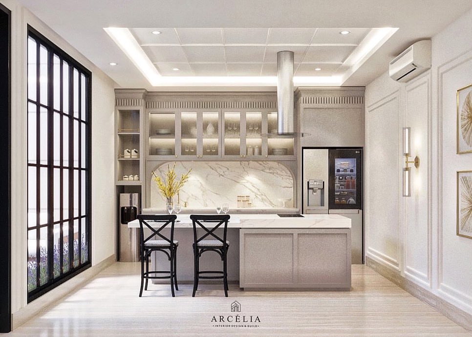 Modern white kitchen with large windows and marble backsplash.